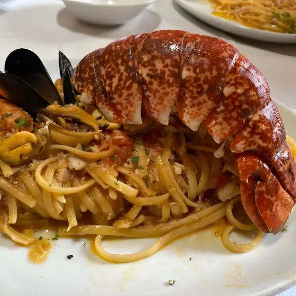 Linguine with a lobster tail, prawns, mussels and tomato sauce.